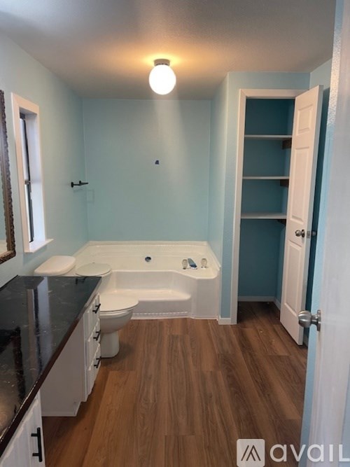 A bathroom with a toilet, sink, and bathtub.