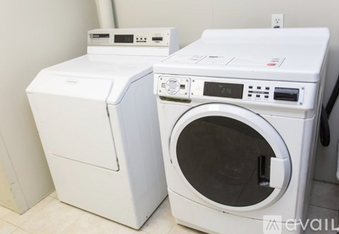 A white washing machine and dryer are stacked on top of each other.