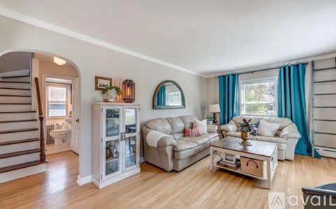 A living room with a white couch and a coffee table.