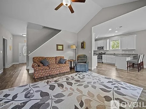 A living room with a couch and a rug in the foreground.