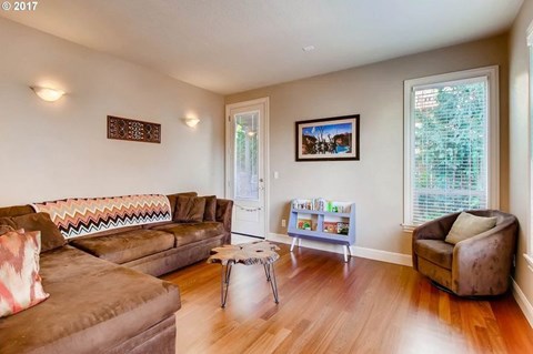 A living room with a brown couch and a coffee table.