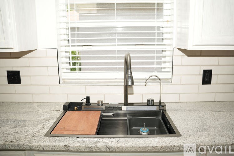 A kitchen sink with a wooden placemat on the counter.
