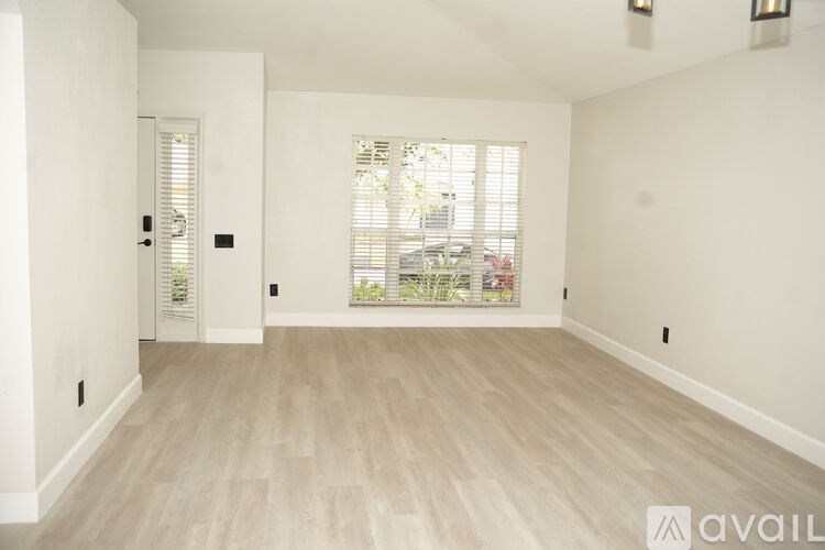 A room with a window and a door.