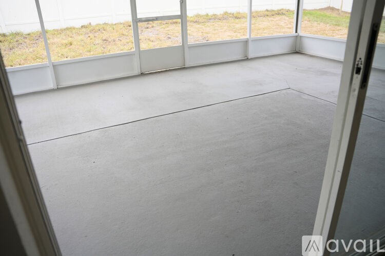 A room with a large window and a view of a field.