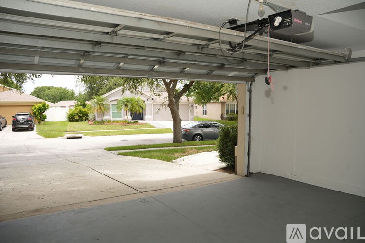 A car is parked in a garage with a white ceiling.
