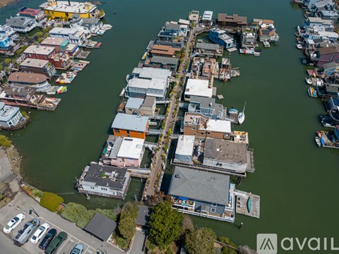 A bird's eye view of a waterfront area with boats and buildings.