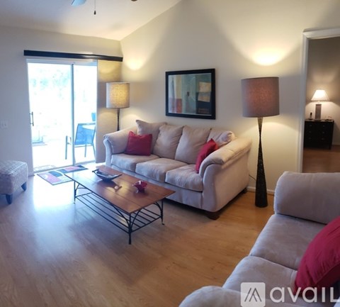A living room with a white couch and a coffee table.