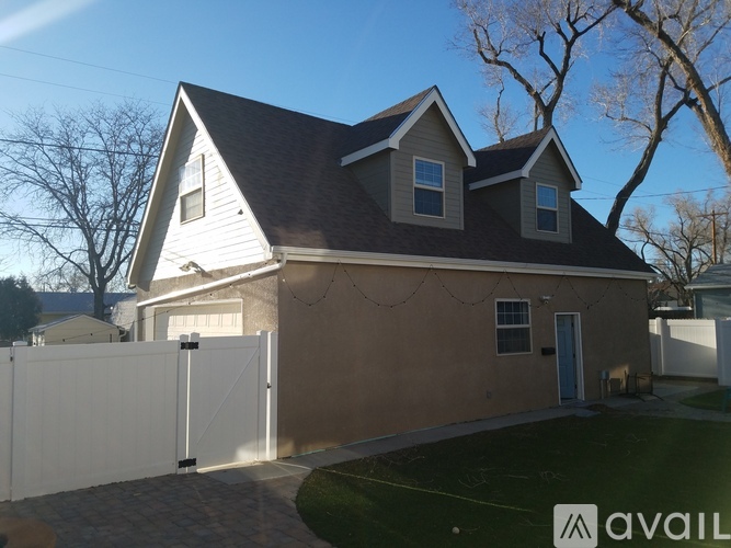 A house with a white fence in front of it.