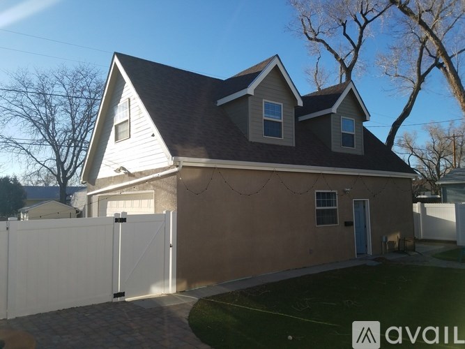 A house with a white fence in front of it.