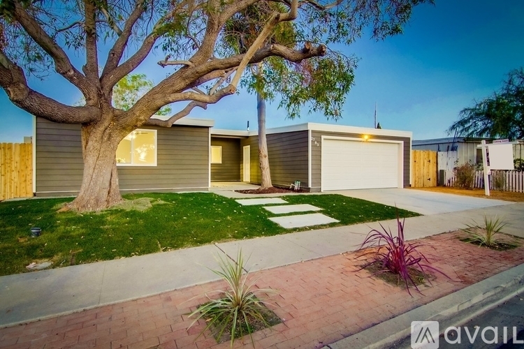 A house with a tree in front of it is for sale.