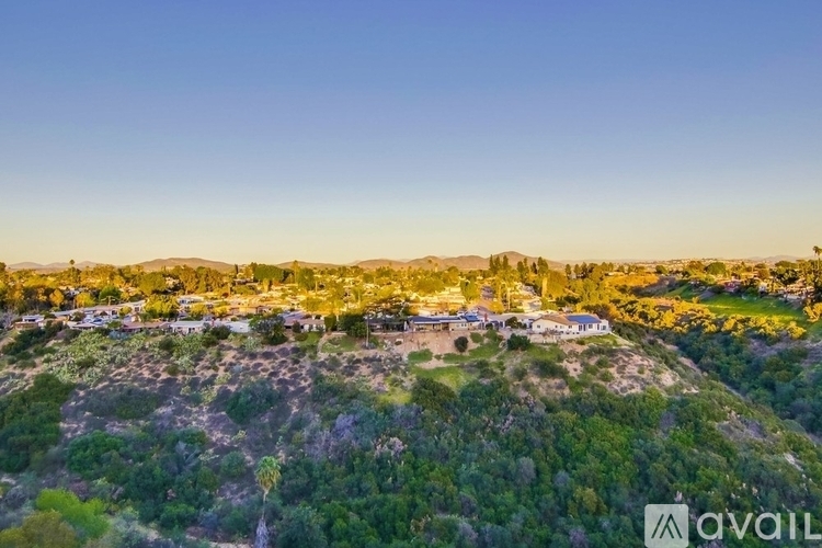A bird's eye view of a residential area surrounded by greenery.