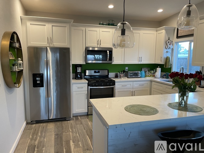 A kitchen with a refrigerator, stove, and oven.