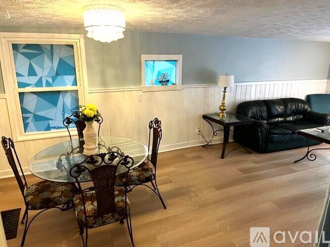 A dining room with a glass table and chairs.