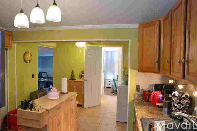 A kitchen with wooden cabinets and a countertop with a sink.