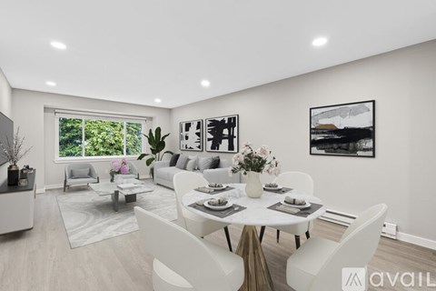 A modern dining room with a large table set for six.