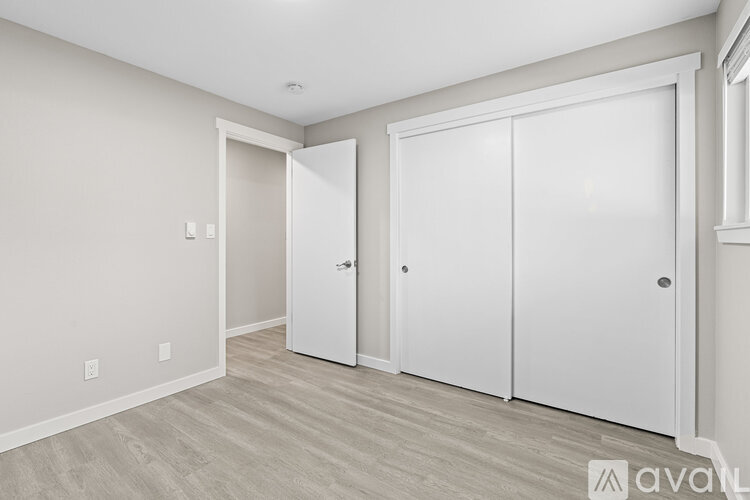 A room with a white door, a white wardrobe and a white cupboard.