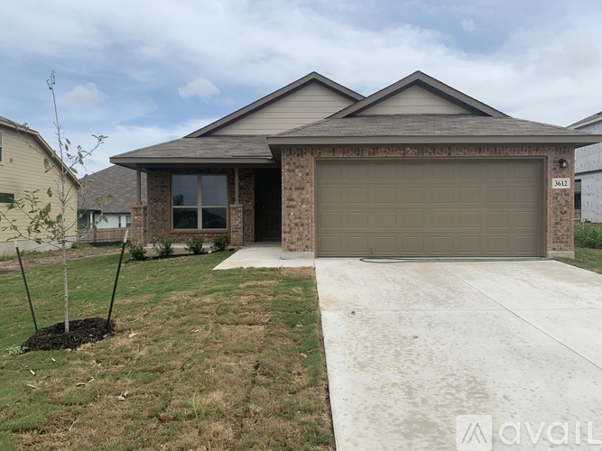A house with a garage and a driveway in front.