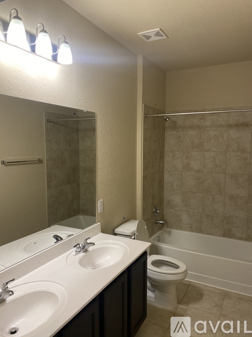 A bathroom with a toilet, sink, and bathtub.