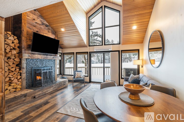 A modern living room with a fireplace and a large TV.