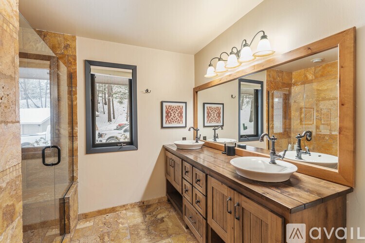 A bathroom with a large mirror and a sink.