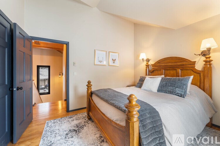A bedroom with a large bed and a wooden headboard.