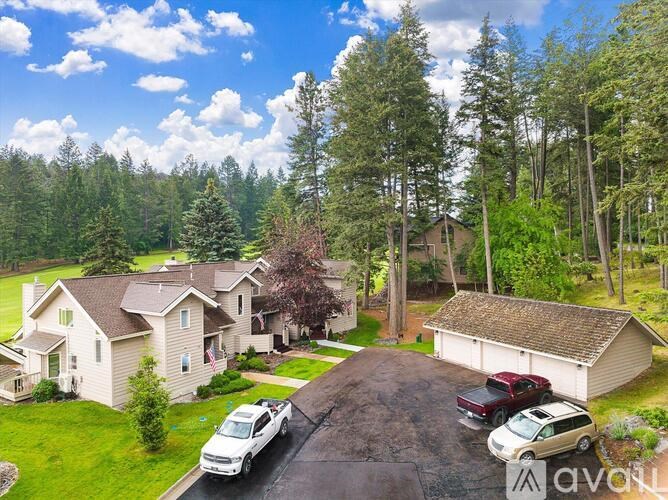 A house with a driveway and a car parked in front.