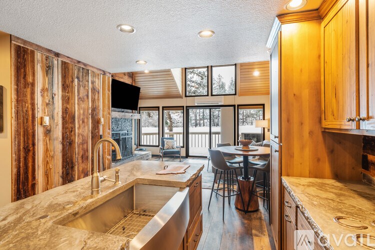 A kitchen with wooden cabinets and a marble countertop.