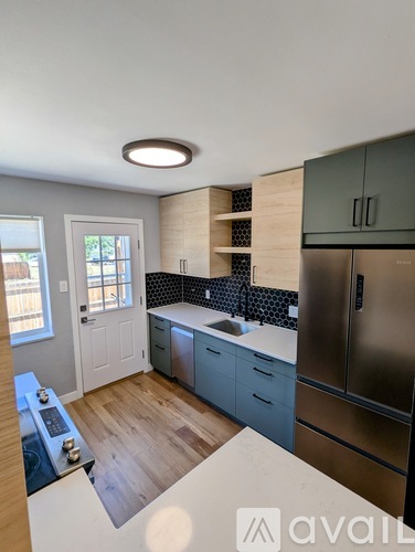 A kitchen with a stove top oven and a refrigerator.