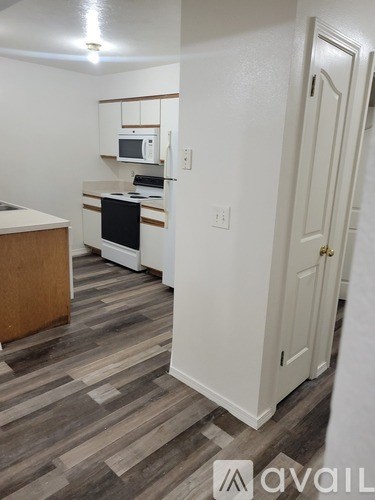 A kitchen with a microwave, oven, and cabinets.
