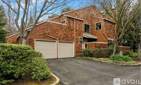A red brick house with a white garage door.