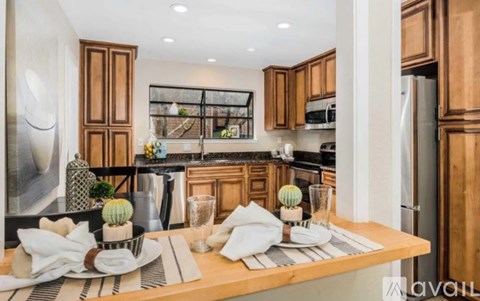 A modern kitchen with wooden cabinets and a central island.