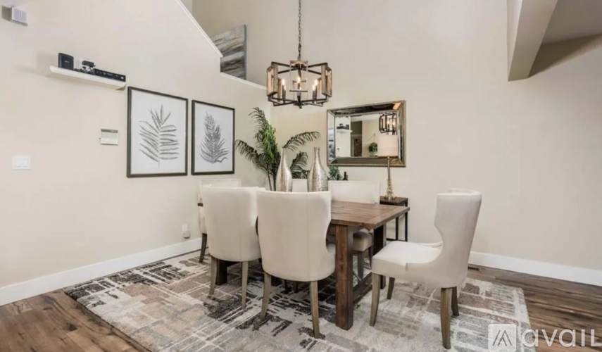 A dining room with a wooden table and chairs.