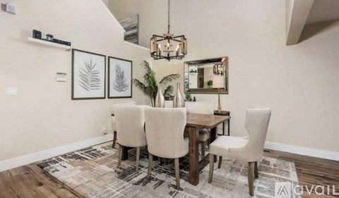 A dining room with a wooden table and chairs.