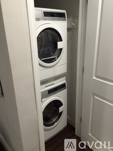 A white washing machine and dryer in a small laundry room.