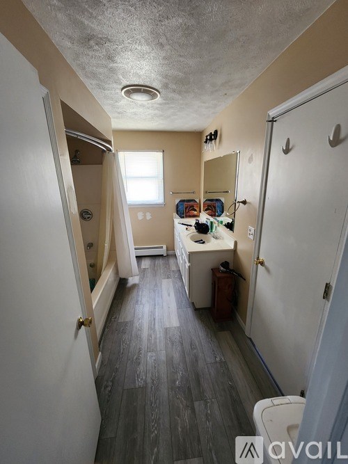 A bathroom with a toilet, sink, and shower.