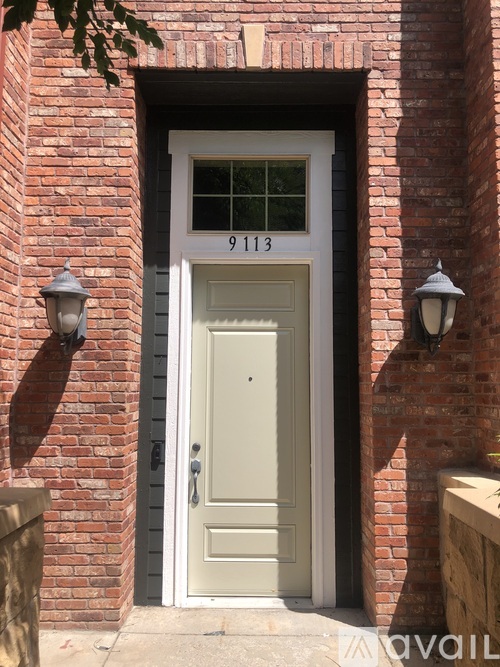 A house number 9113 is written on the glass of a door.