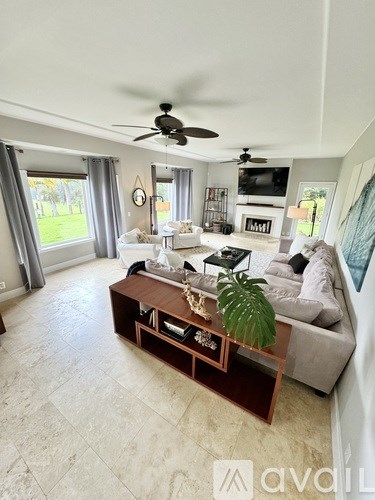 A living room with a large couch and a coffee table.