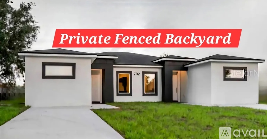 A modern house with a private fenced backyard.