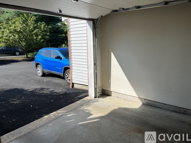 A blue car is parked in a garage.