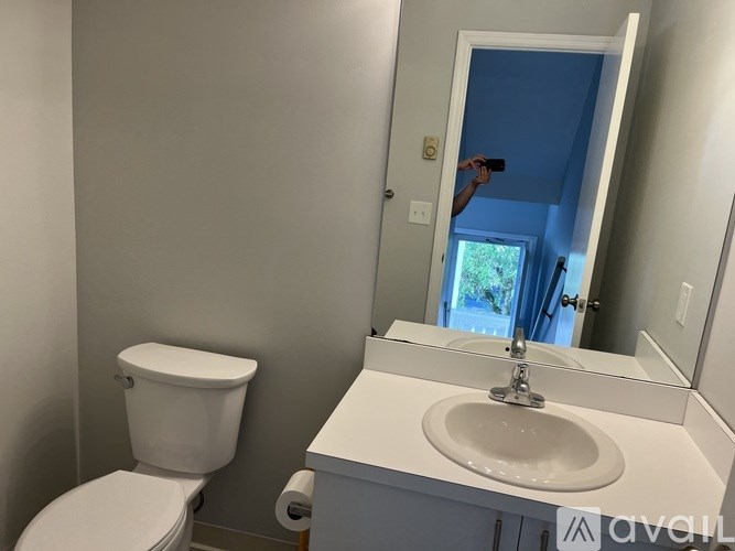 A white toilet and sink in a bathroom.