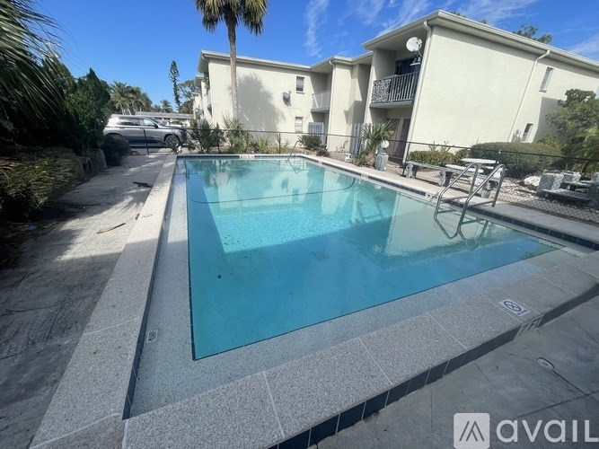 A swimming pool in a residential area with a building in the background.
