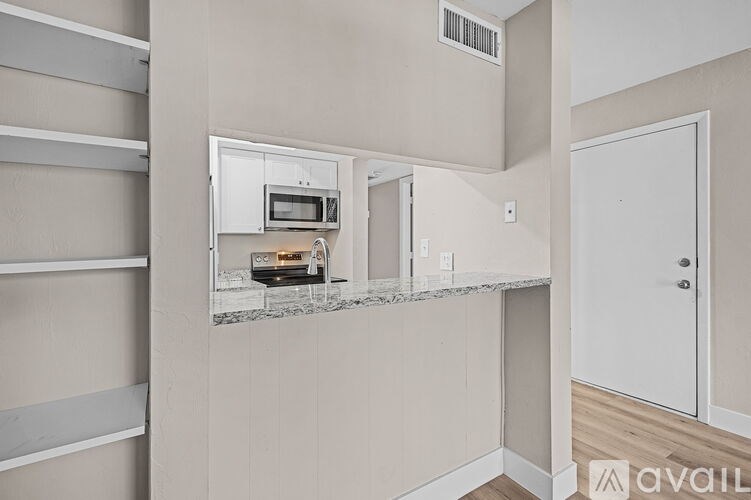 A kitchen area with a microwave, oven, and a countertop.