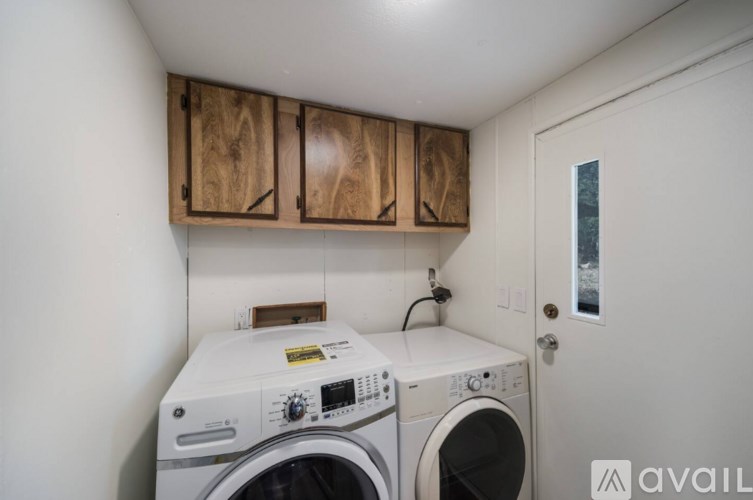A washing machine and dryer in a small laundry room.