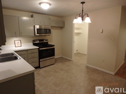 A kitchen with a stove top oven and microwave.