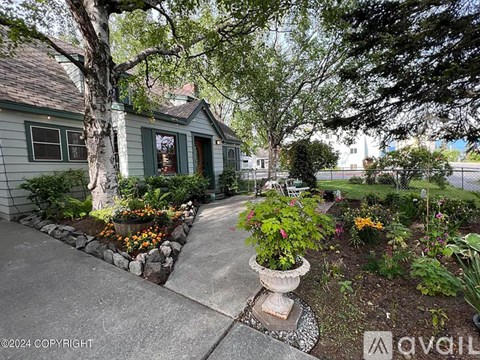 A house with a grey exterior and a green lawn.