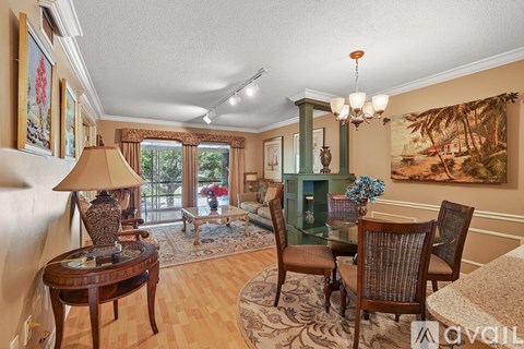 A living room with a wooden table and chairs.