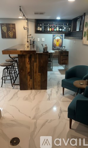 A bar with a wooden counter and stools.