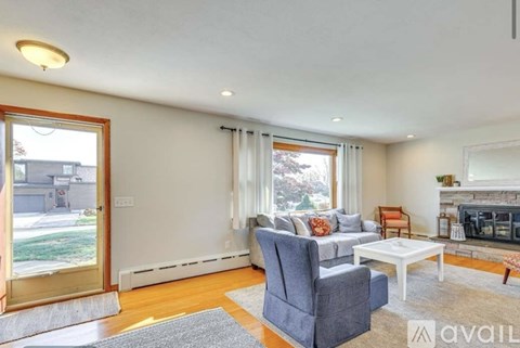 A living room with a grey sofa and a white coffee table.