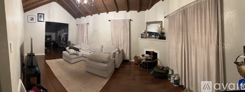 A living room with a white couch and a fireplace.