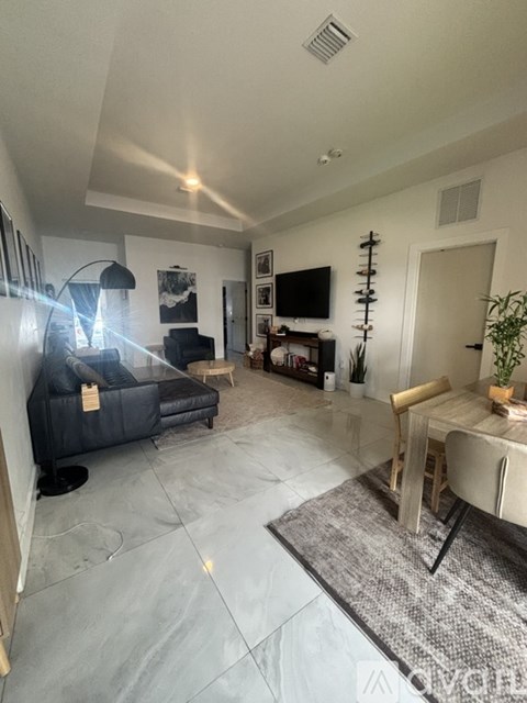 A living room with a grey couch and a television.